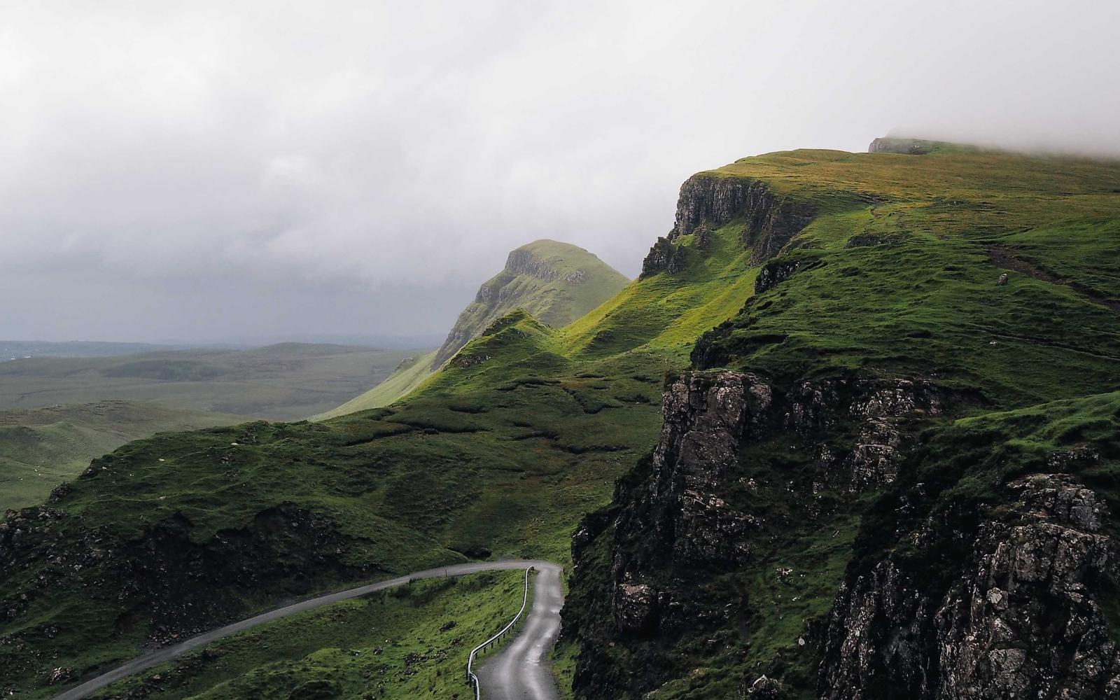 A quiet green landscape beneath a wide sky